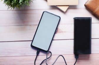 Power bank charging a smartphone on a desk